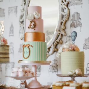 three assorted cakes near white framed mirror